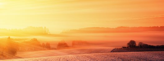 picture of a lighthouse against a red sky