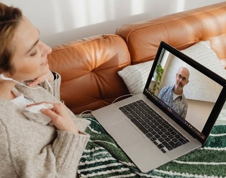 Picture of someone on a Zoom call using their laptop